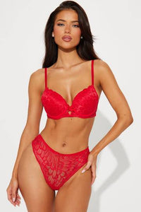 a woman in a red bra and panties