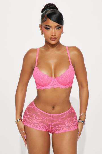 a woman in a pink bra and panties