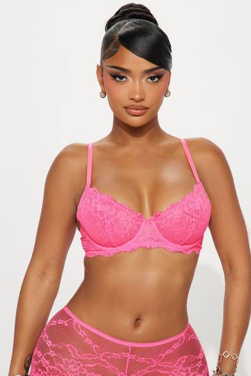 a woman wearing a pink bra and panties