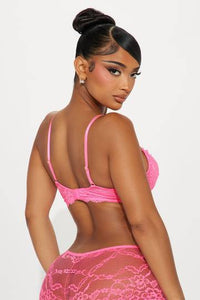 a woman wearing a pink lingerie and panties