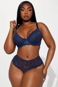 a woman in a blue lingerie posing for the camera