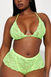 a woman in a neon green bra and panties