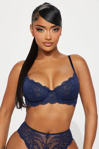 a woman in a blue bra and panties