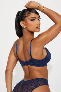 a woman in a blue lingerie posing for a picture