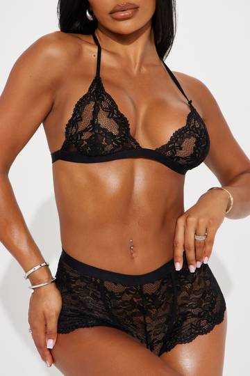 a woman in a black lingerie posing for the camera