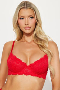 a woman wearing a red bra and panties