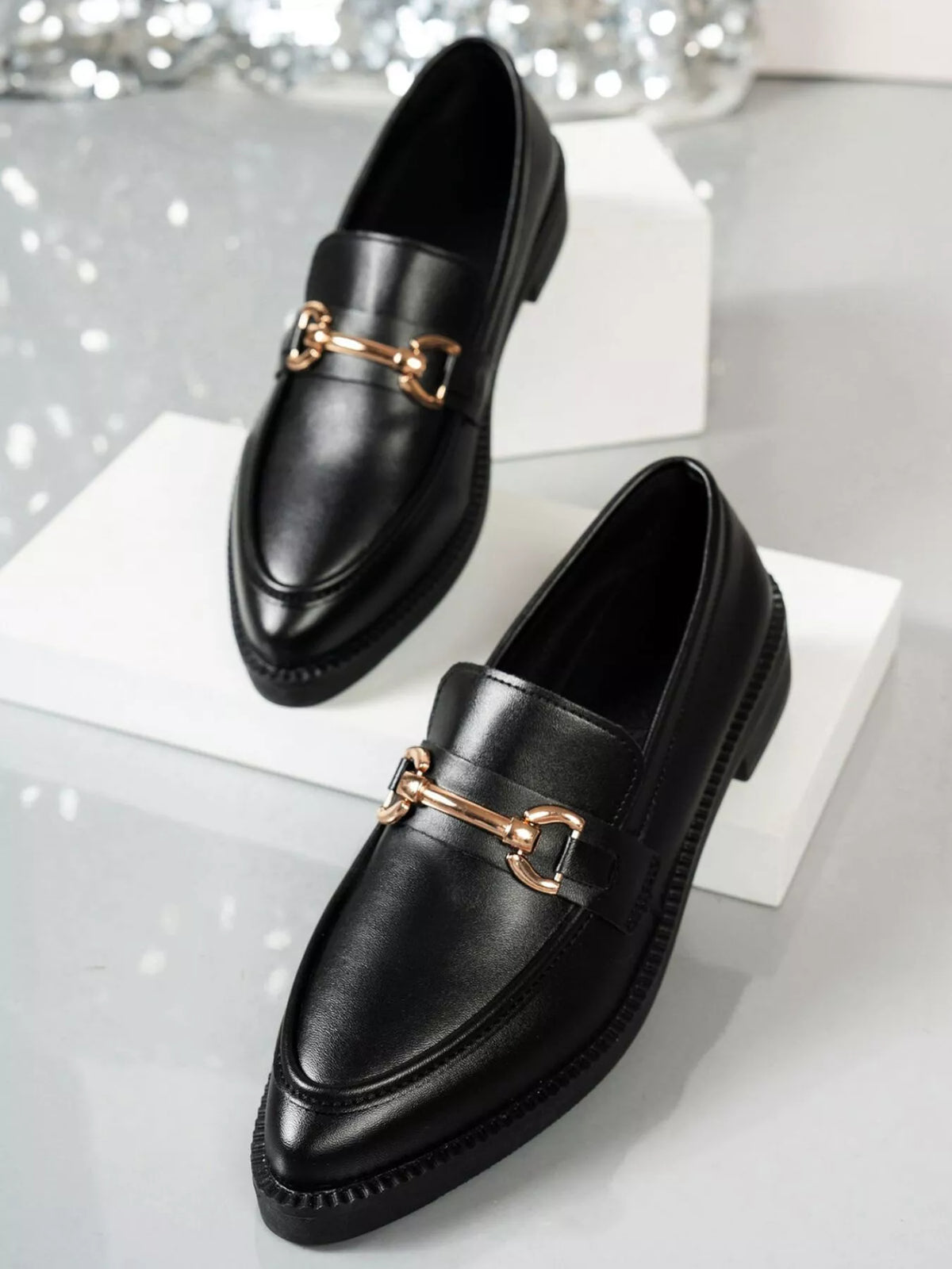 Point toe black block heel loafers with gold detail, stylish and comfortable shoes for everyday wear.