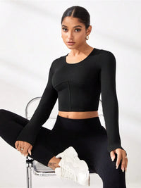 Round neck long sleeve black active t-shirt, perfect for affordable activewear, styled with matching leggings.