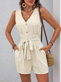 Striped V-neck button front belted romper, stylish summer outfit with pockets and casual accessories.