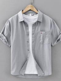 Men's plus size short sleeve button-up shirt in gray, featuring a pocket and layered white t-shirt underneath.