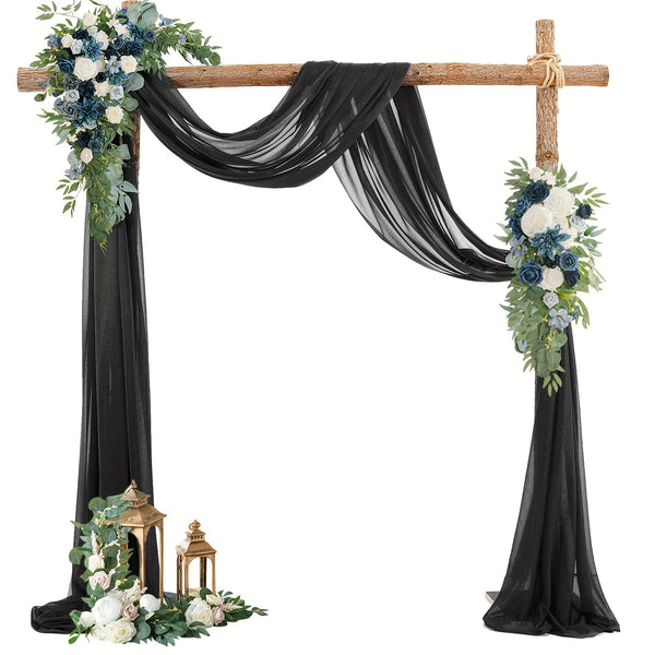 a black wedding arch decorated with flowers and greenery