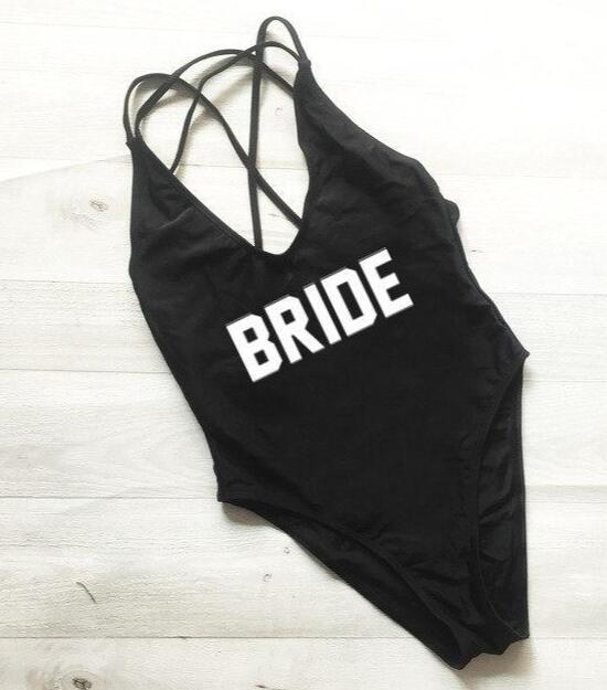 a black swimsuit with the word bride printed on it