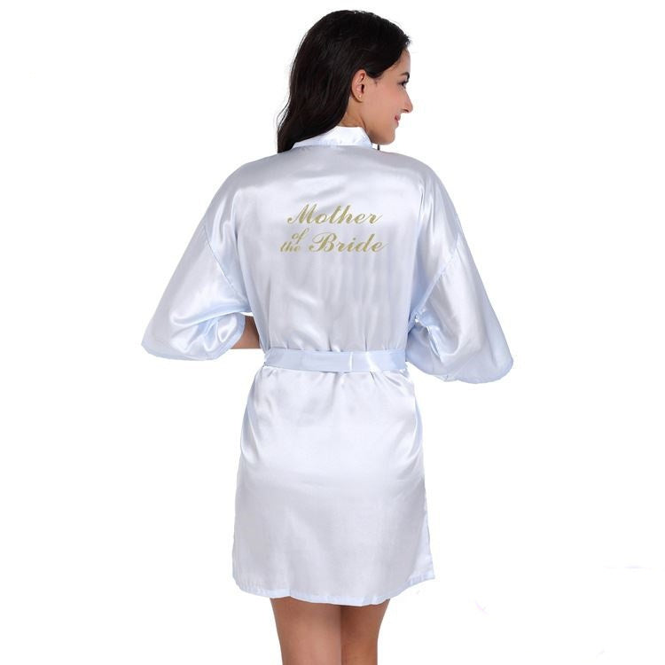 a woman in a white robe with gold lettering