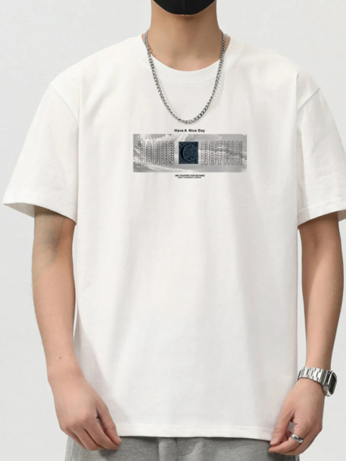 Men's white short sleeve t-shirt with graphic print and chain necklace, casual streetwear style.