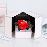 a white box with a red rose in it