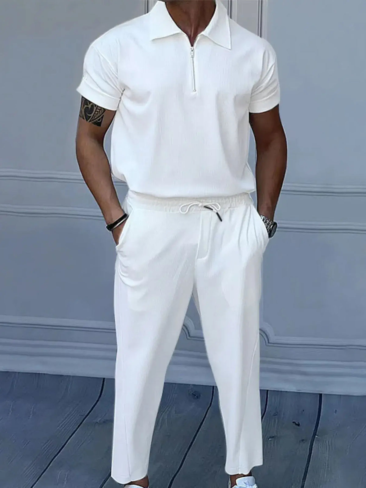 Men's full size quarter zip short sleeve polo and pants set in white, featuring drawstring and pocket design.