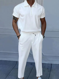 Men's full size quarter zip short sleeve polo and pants set in white, featuring drawstring and pocket design.