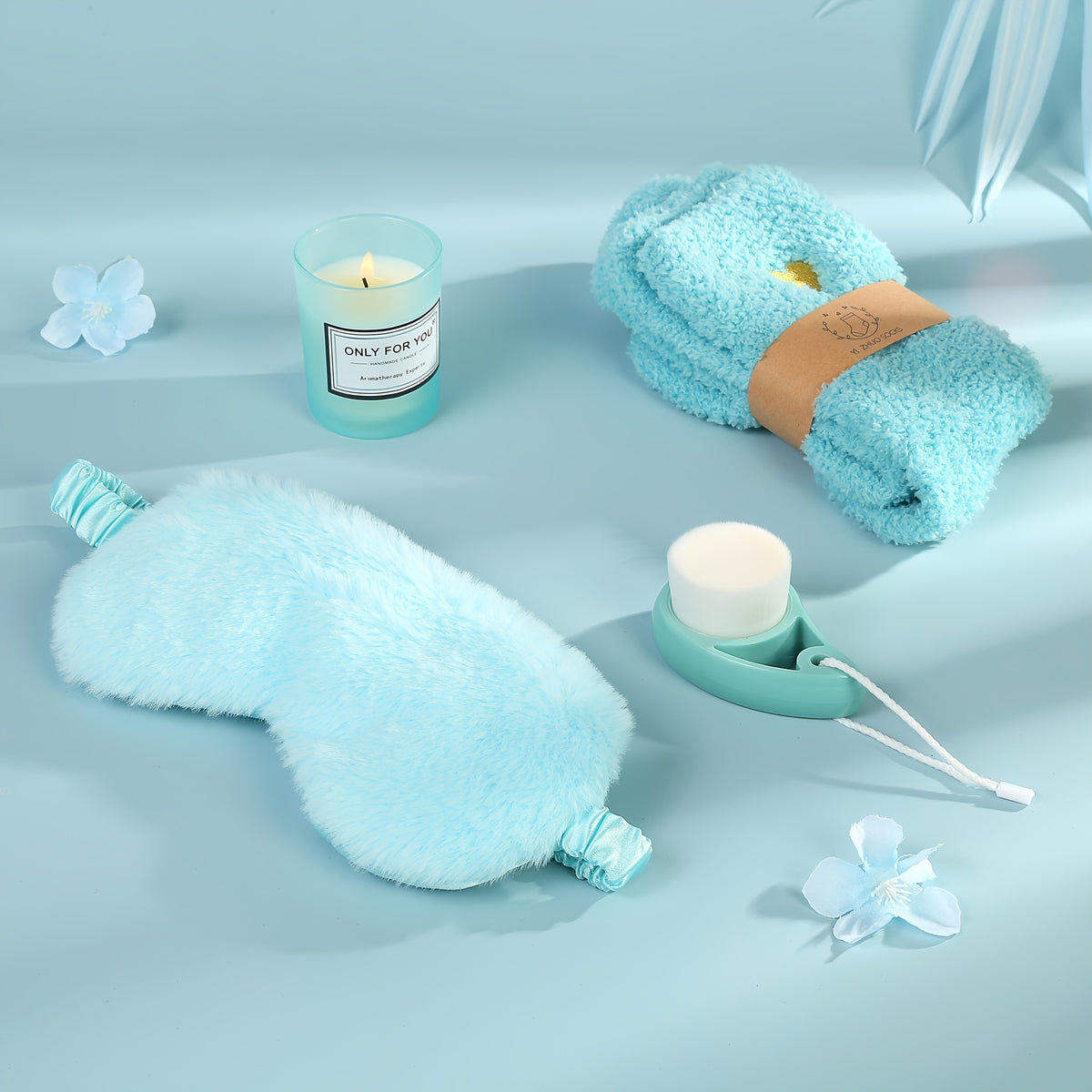 a bottle of lotion, a towel, and a candle on a blue surface