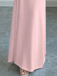 Close-up of the hem of a pink bodycon maxi dress, perfect for luxurious weddings and special occasions.