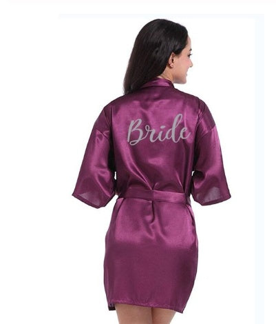 a woman in a purple robe with the word bride on it
