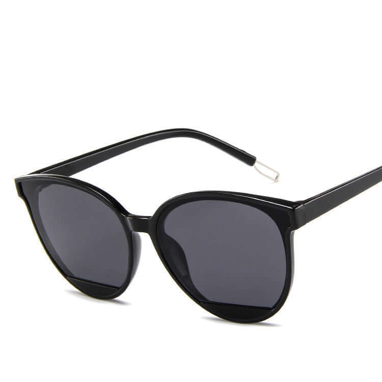 Ladies round frame sunglasses in black, perfect for formal wear & accessories NZ, combining elegance and comfort.