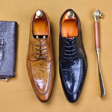 three men's shoes, a tie, and a wallet