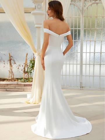 a woman in a white wedding dress standing in front of a gazebo