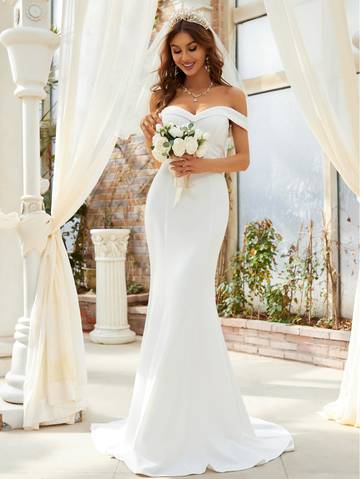 a woman in a wedding dress standing in front of a gazebo