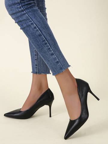 a woman's legs in high heels and jeans