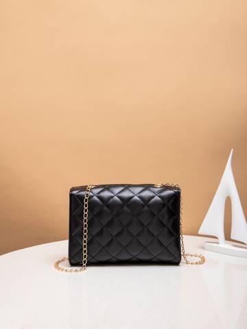 a black purse sitting on top of a white table