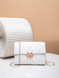 a white purse sitting on top of a white table