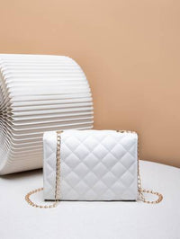 a white purse sitting on top of a white table