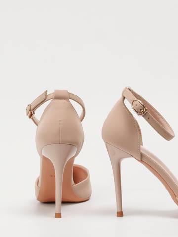 a pair of nude colored high heeled shoes