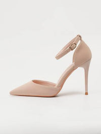 a pair of nude colored high heeled shoes