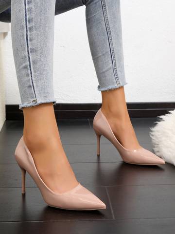 a woman's legs in high heels and jeans