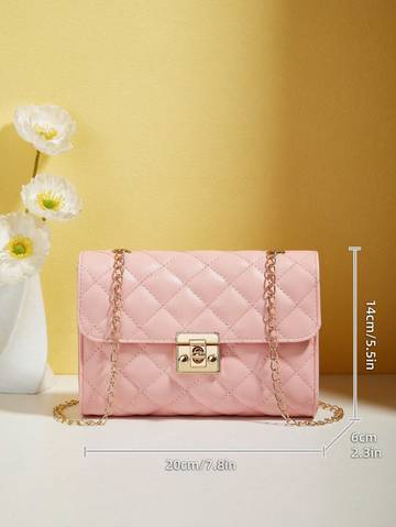 a pink purse sitting on top of a table next to a vase of flowers