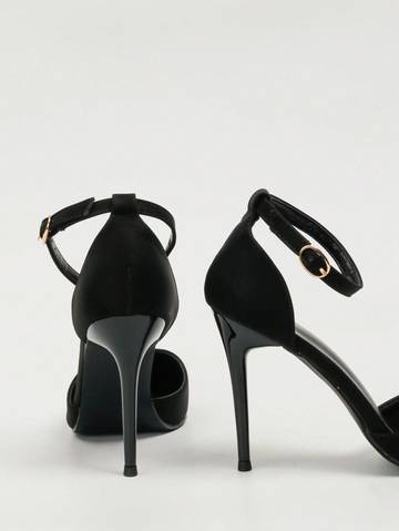 a pair of black high heeled shoes on a white background