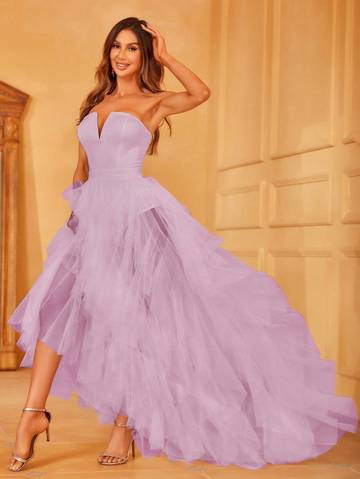 a woman in a purple dress posing for a picture