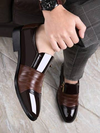 a person wearing a brown and black dress shoe