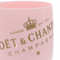 a close up of a pink cup with a crown on it