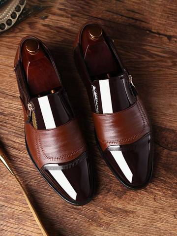 a pair of brown shoes sitting on top of a wooden table