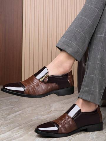 a person wearing a brown and black loafer