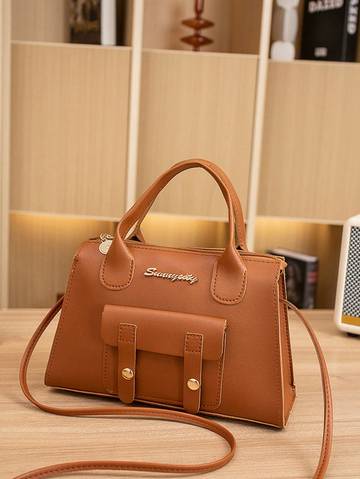 a brown purse sitting on top of a wooden table