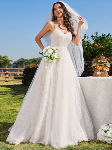 a woman in a wedding dress posing for a picture