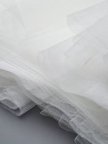 a close up of a white fabric on a gray surface