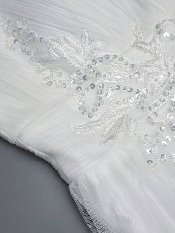 a close up of a white wedding dress