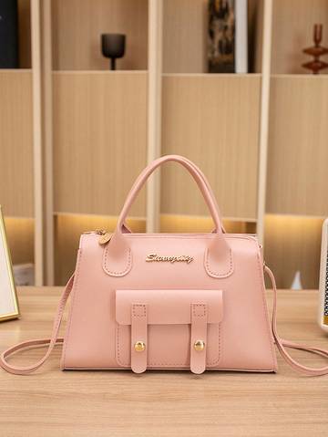 a pink purse sitting on top of a wooden table