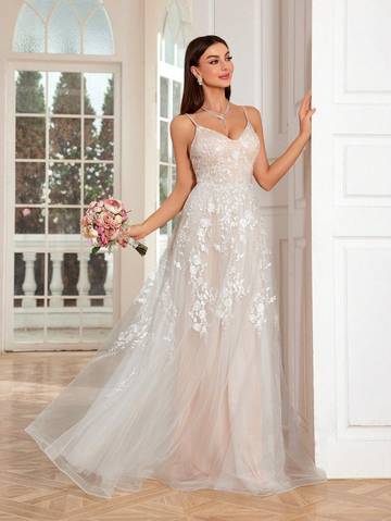 a woman in a wedding dress standing in a room