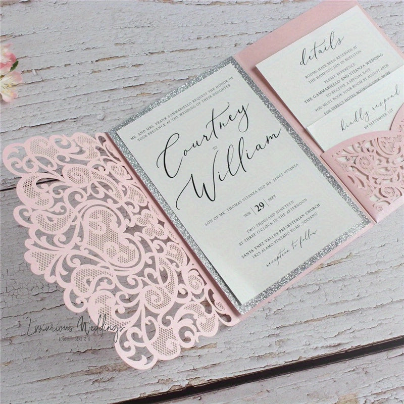 a pink and silver wedding card with a lace border