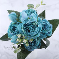 a bouquet of blue flowers sitting on top of a table